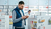 Male customer holding box of medicine