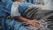 Elderly patient wearing pulse oximeter