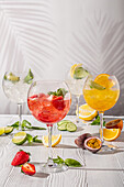 Various sangria drinks, decorated with fruit and mint
