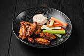 Chicken wings with carrot and celery sticks