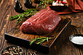 Raw top blade beef steak with rosemary and spices