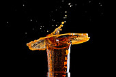 Dark beer with sparkling foam in the glass
