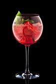Alcoholic strawberry and mint cocktail with ice cubes