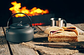 Puff pastry with jam filling and teapot by the campfire