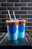 Iced blue latte in a disposable cup