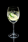 Cocktail with lemon and cucumber in a wine glass