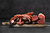 Smoked sausages and ham on a wooden board