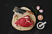 Raw top round roast beef with garlic and spices