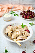 Sour cherry dumplings with fresh cherries and melted butter