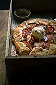 Apple galette with a scoop of vanilla ice cream and caramel sauce