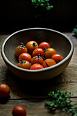 Still life of a bowl of fresh cherry tomatoes