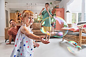 Father with children playing with bubbles