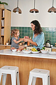 Mother with daughter in kitchen