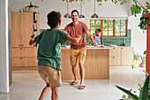 Happy father and son in kitchen