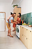 Parents with daughter cooking in kitchen