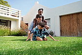 Father with children playing in backyard