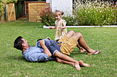 Father with children playing in backyard