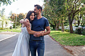 Couple embracing on street