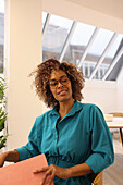 Portrait of smiling woman in creative studio