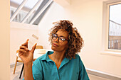 Portrait of woman holding glass cube in creative studio