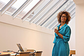 Smiling woman standing in creative studio