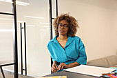 Portrait of woman sitting in creative studio