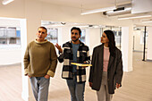 Coworkers talking in empty office