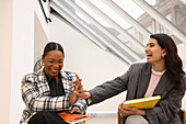 Businesswomen laughing in office