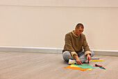 Man sitting on floor in modern office