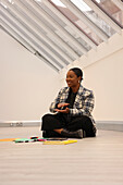 Woman sitting on floor in modern office