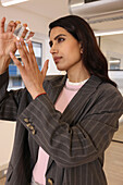 Businesswoman looking at glass cube