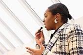 Woman talking to microphone in office