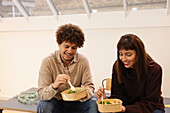 Coworkers eating salads in office