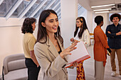 Employee holding notebook during team meeting