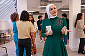 Employee holding coffee during team meeting