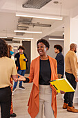 Employee holding folder and smiling during meeting