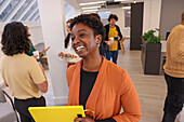 Employee holding folder and smiling during meeting