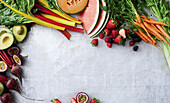 Fresh summer fruit and vegetables on a white background