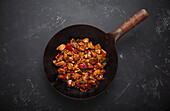 Kung Pao chicken in a wok with peanuts