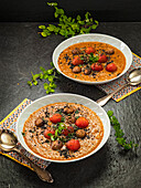 Aubergine soup with cherry tomatoes, mushrooms and herbs