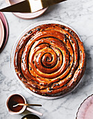 Giant hot cross bun with maple syrup glaze