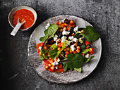 Mediterranean chickpea salad with ajvar, feta cheese and baby chard