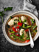 Summer vegetable soup with semolina dumplings and bacon