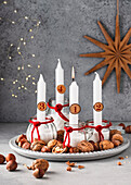 Advent wreath in glass jars with white candles and nuts