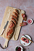 Grain baguette with beetroot spread and oregano
