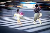 Tourists and business people crossing the street at Harajuku Japan