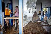 Friends cleaning after floods, in the Alfacs campsite, Alcanar, Tarragona, Spain. 3rd Sep, 2023