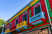 Colorfully painted balconies on buildings along Magallanes Street in Caminito, La Boca in Buenos Aires, Argentina.