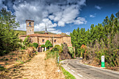 The Santa Maria Church stands prominently in Yanguas, Soria, showcasing its historic architecture amid a serene landscape.