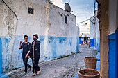 Rabat, Morocco, Apr 24 2015, Two women stroll along the colorful blue and white alleys of the historic Kasbah of the Udayas in Rabat, Morocco, enjoying the vibrant atmosphere.